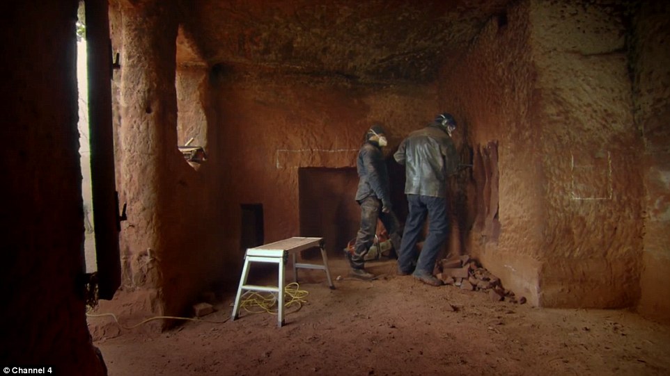 Pictured: Presenter Kevin McCloud helps Mr Mastropieto create a built-in wardrobe in what will eventually become one of the cave's bedrooms