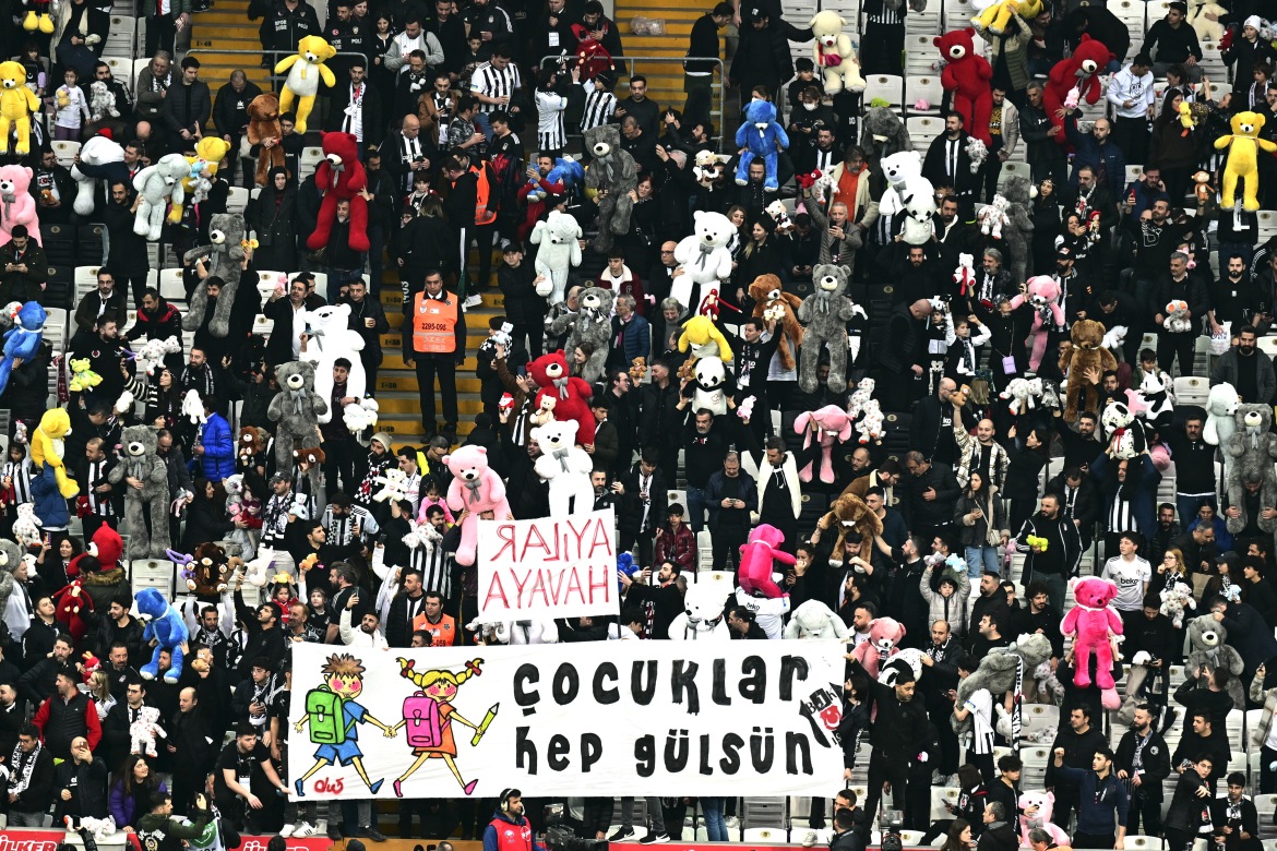 Fans throw toys onto the pitch during the Turkish Super League football match