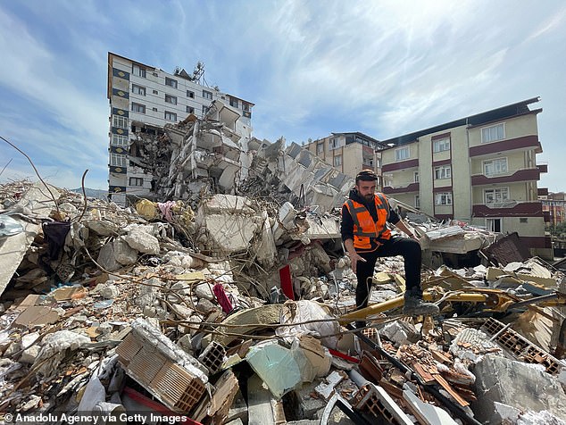 The workers were seen going through a narrow opening among the rubble then breaking open a hole in a door to access the room in the basement, which appeared to have sustained little damage