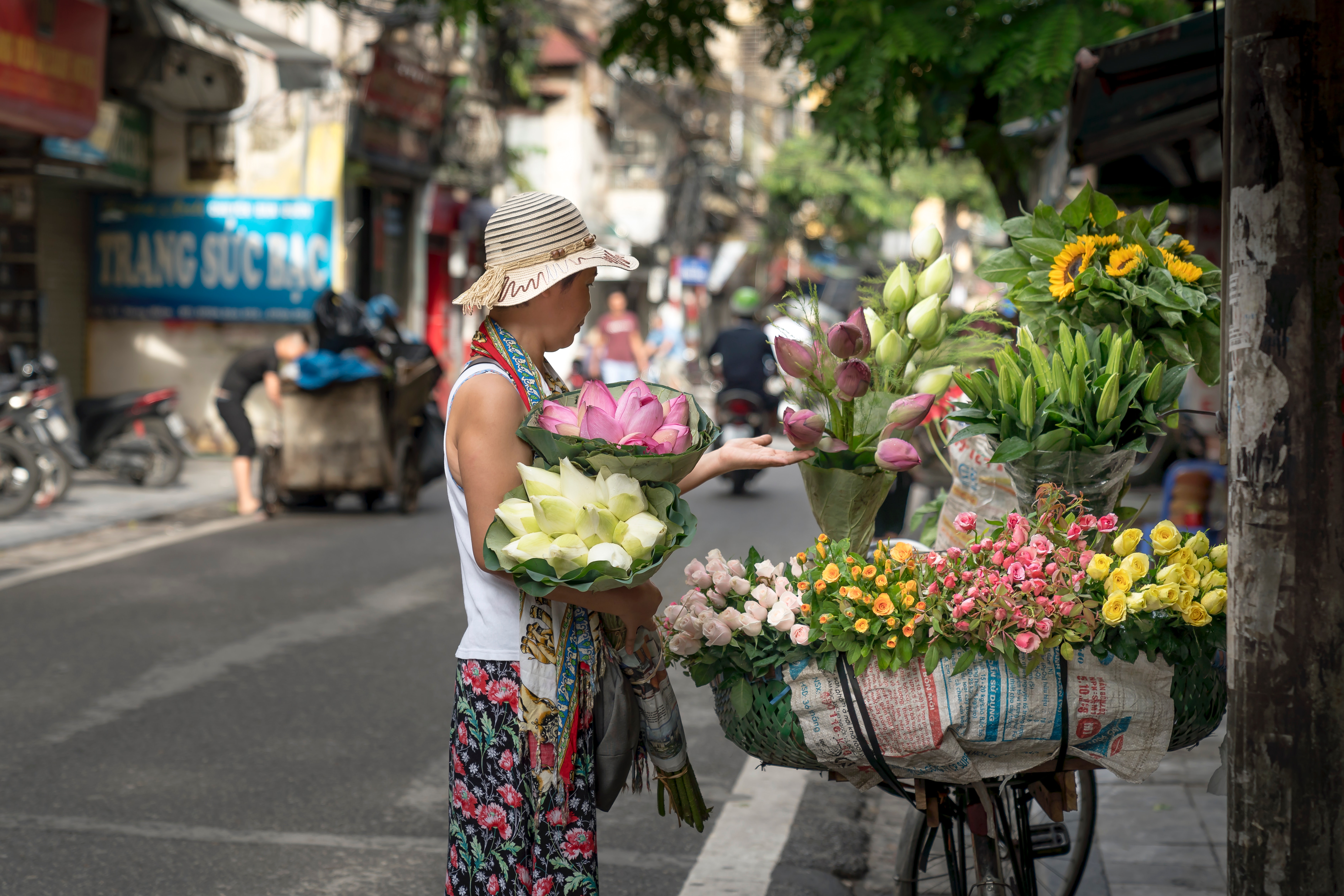 Woman Selling Flowers on Roadside · Free Stock Photo